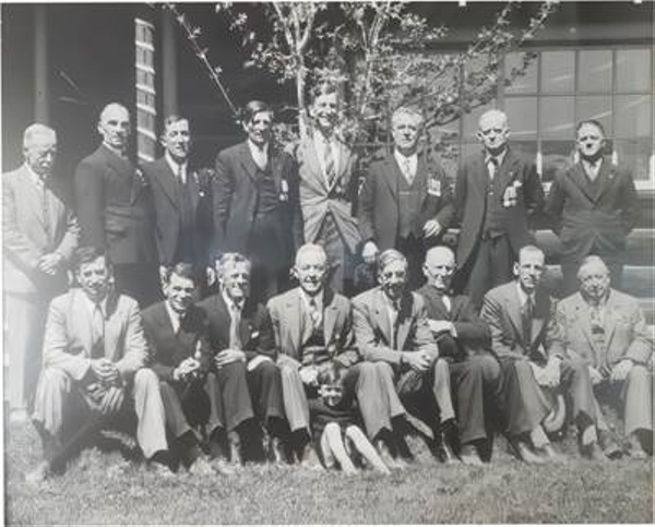 A group of men posing for a photo
         
         Description automatically generated
